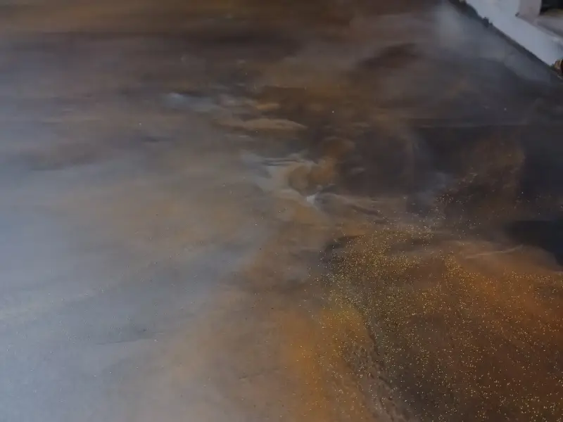 Epoxy flooring covered in oil in a Winnipeg warehouse.