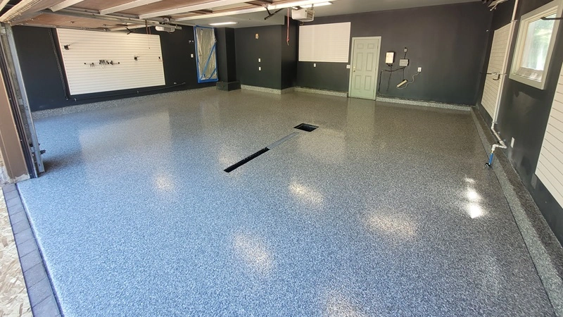 Durable polyaspartic floor coatings applied to a large garage for long-lasting protection.