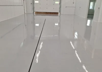 Glossy white polished concrete floors in a bare room.